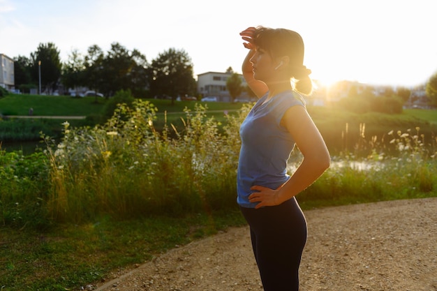 Woman doing sports in the countryside at sunset