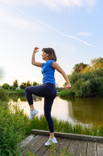 Woman doing sports in the countryside at sunset