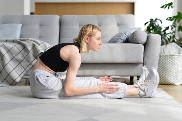 Woman doing stretching exercise at home