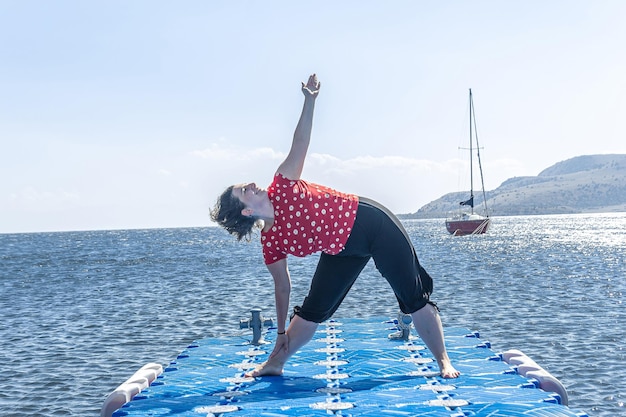 woman doing yoga exercise on the beach woman relaxing on the beach woman doing yoga