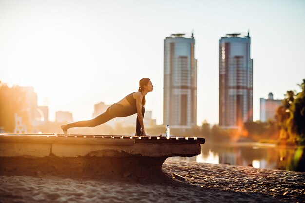 Woman doing yoga outdoors in the summer