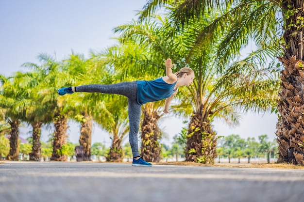 Woman doing yoga in a tropical park