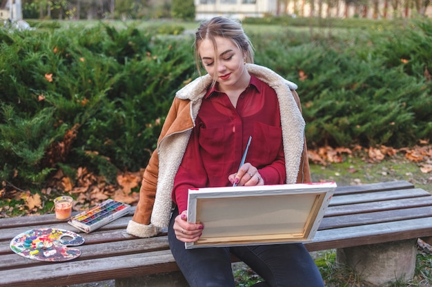 Woman draws a picture holding it in her hands