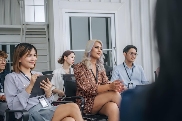 a woman in a dress is sitting in a chair with other people