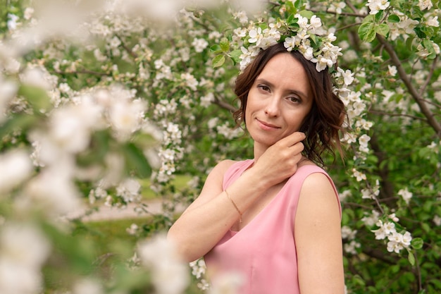 A woman in a dress near a blooming spring tree Romantic happy mood