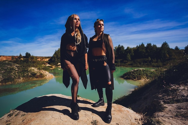 Woman dressed in a steampunk suit against the background of a dirty lake