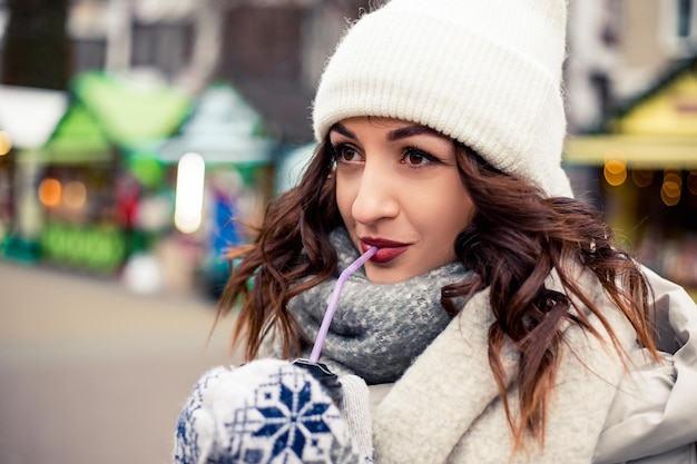 Woman drink hot coffee at winter fair