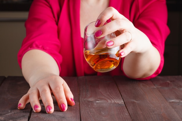 Woman drink whiskey from glass