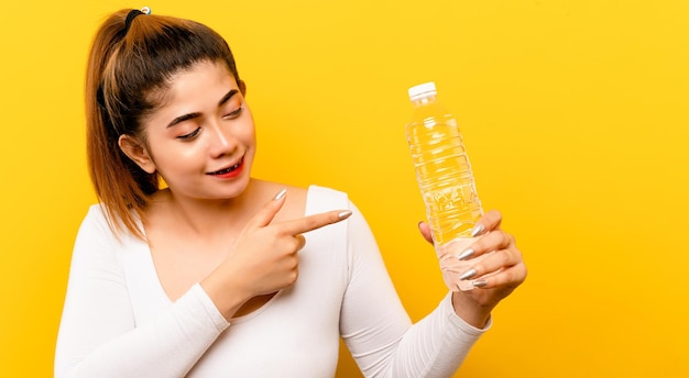 Woman drinking clean water from a bottle hand holding a water bottle healthy drinking water concept