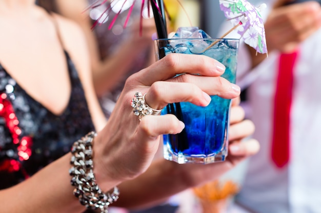 Woman drinking cocktails in cocktail bar