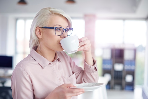 Woman drinking coffe at office