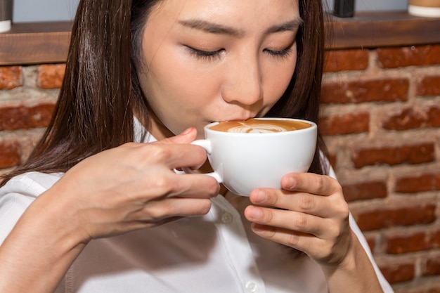 Woman drinking coffee at coffee shop