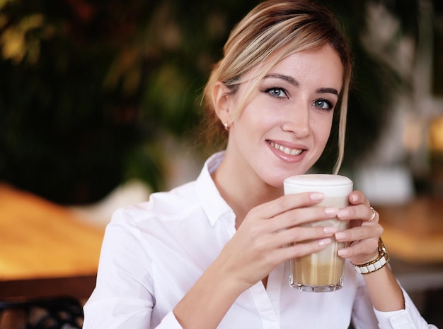 Woman drinking coffee in the morning at restaurant