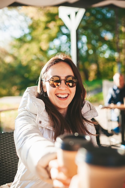 Woman drinking coffee in the outdoors cafe