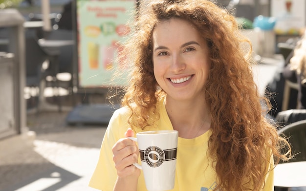 Woman drinking coffee in urban city cafe.