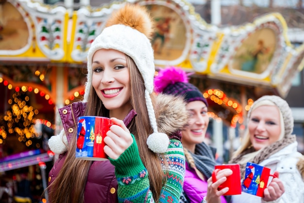 Woman drinking eggnog on German Christmas Market