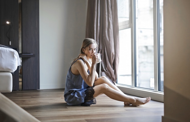 Woman drinking in the floor