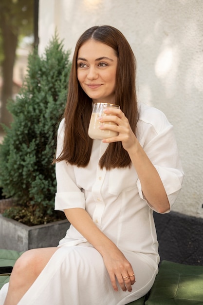 Woman drinking iced coffee