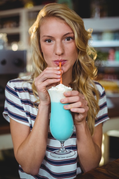  woman drinking milkshake with a straw