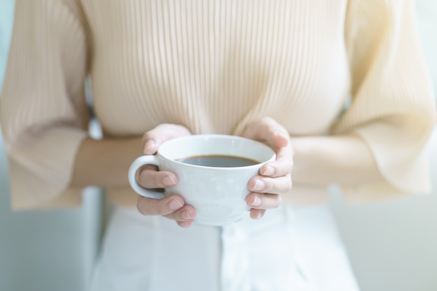 Woman drinking tea or coffee in the morning