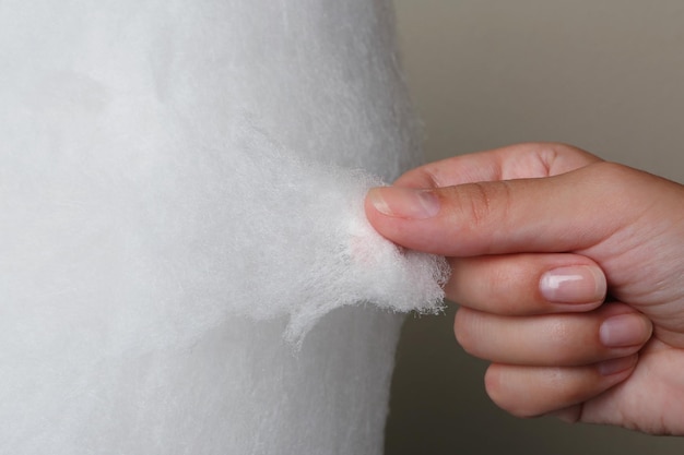 Woman eating cotton candy closeup