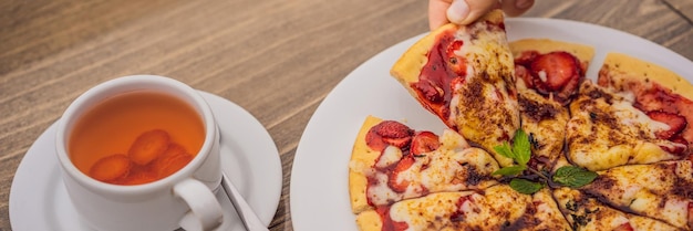 Woman eating delicious strawberry pizza on a balinese tropical nature background bali island