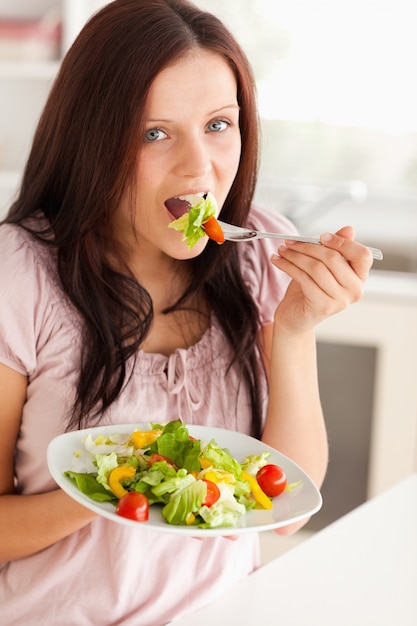 Woman eating salad