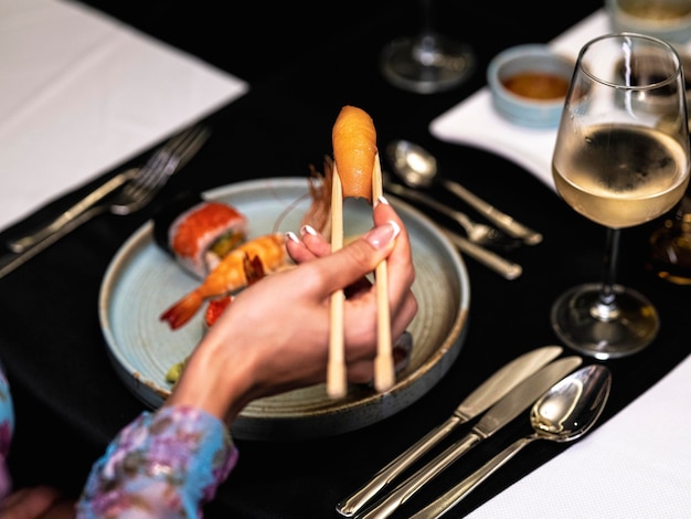 A woman eating sushi for dinner