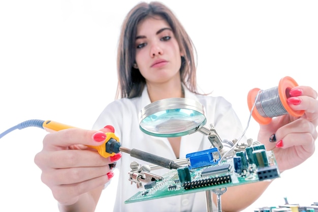 Woman Electronic Technician Repair Electronic Equipment using Electric Soldering Iron