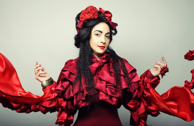 Woman in elegance red costume with red hat.