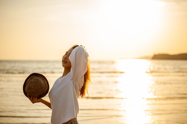 Woman Enjoying Beautiful Sunset on the Beach