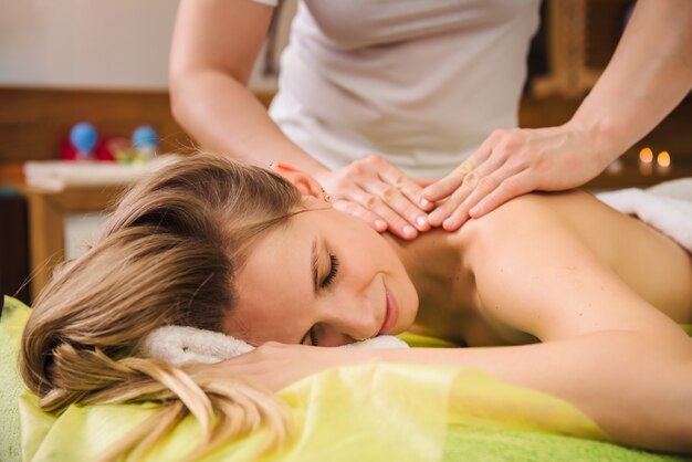 Woman enjoying classical neck and shoulder massage