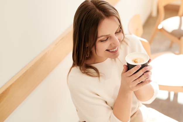 Woman enjoying coffee in cafe in morning