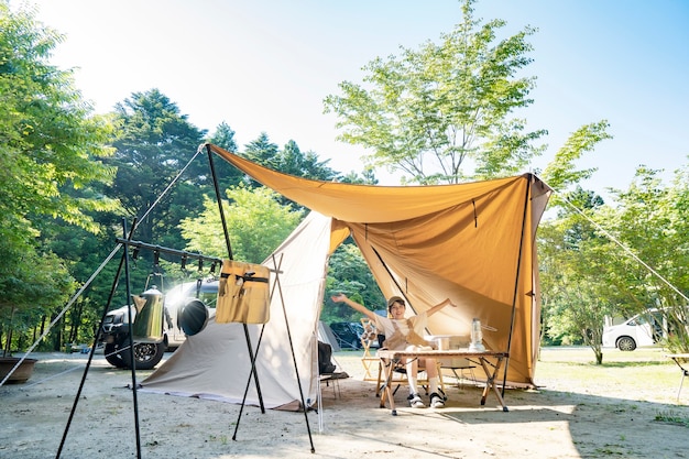 A woman enjoying a solo camp on fine day