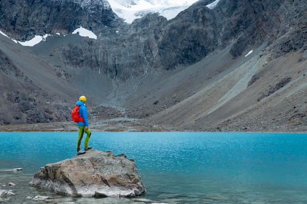 Woman enjoys Blaisvatnet blue lake in the mountains of the Lyngen Alps Lyngenfjord Norway