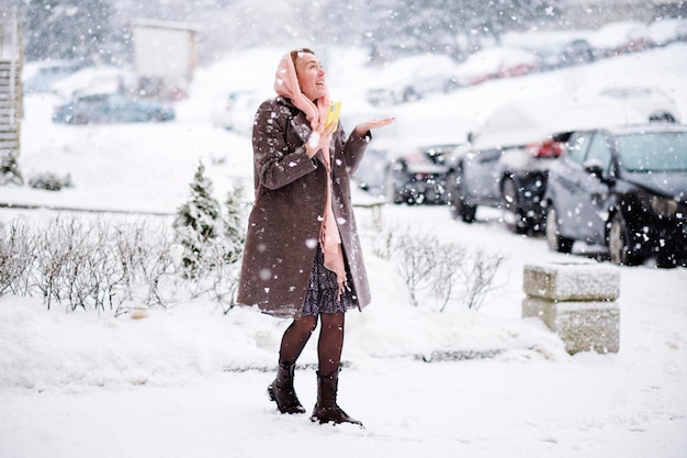 A woman of European model appearance enjoys a lot of snow