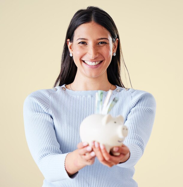 Woman excited for financial investment savings and planning for future investment holding piggybank and smiling Banking money success and finance profit budget cash notes for financial growth