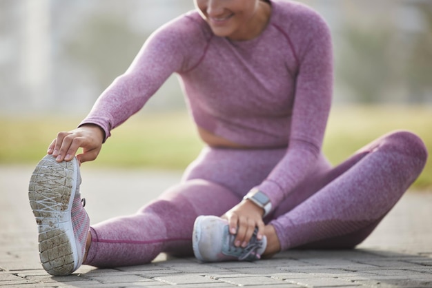 Woman exercise and fitness while stretching outdoor at a city park for health and wellness with cardio training Athlete female sitting for warm up workout and running for healthy lifestyle and body