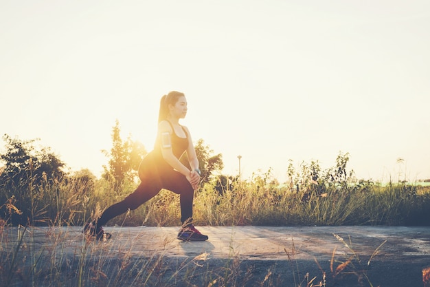  Woman exercise outdoor in Sunset