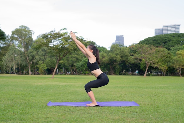 Woman Exercise Yoga In Park Ready For Healthy Lifestyle In Nature