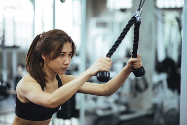 Woman exercising building muscles at gym