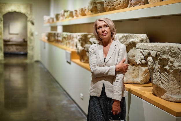 Woman exploring medieval expositions in museum