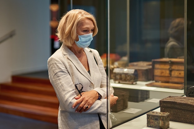 Woman exploring medieval expositions in museum