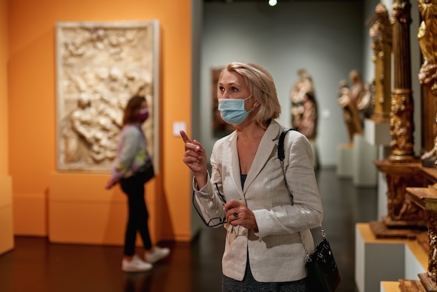 Woman exploring medieval expositions in museum