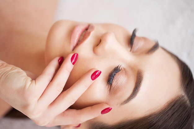 Woman Eye with Long Eyelashes. Beautiful Young Woman During Eyelash Extension