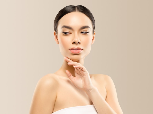 Woman face beauty hand touching   healthy skin natural makeup beautiful female beige background