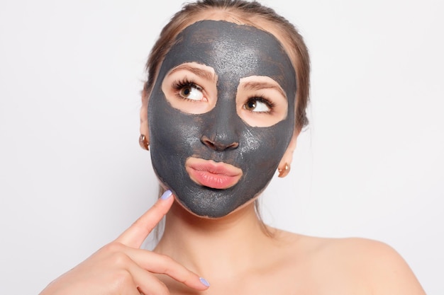 Woman Face Mask Portrait Of Beautiful Girl Removing Cosmetic Black Peeling Mask From Facial Skin Closeup Of Attractive Young Woman With Natural Makeup And Cosmetic Peel Mask On Face High Resolution