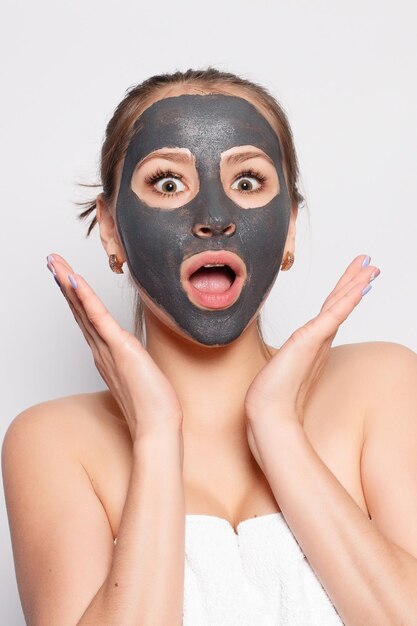 Woman Face Mask Portrait Of Beautiful Girl Removing Cosmetic Black Peeling Mask From Facial Skin Closeup Of Attractive Young Woman With Natural Makeup And Cosmetic Peel Mask On Face High Resolution