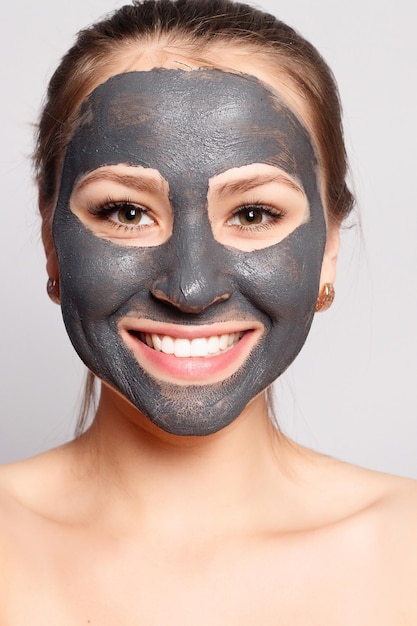 Woman Face Mask Portrait Of Beautiful Girl Removing Cosmetic Black Peeling Mask From Facial Skin Closeup Of Attractive Young Woman With Natural Makeup And Cosmetic Peel Mask On Face High Resolution