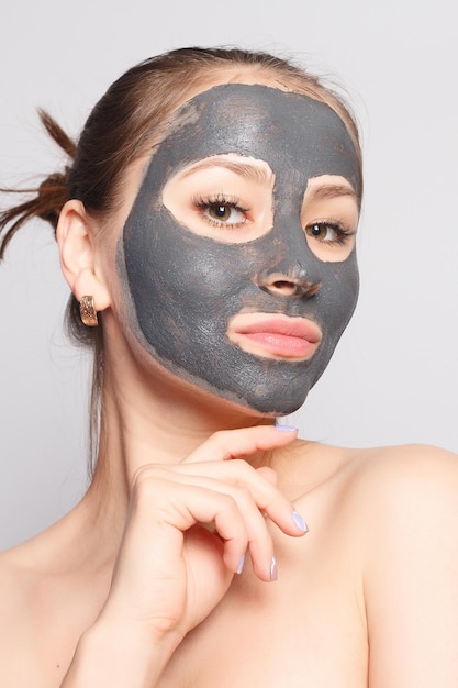 Woman Face Mask Portrait Of Beautiful Girl Removing Cosmetic Black Peeling Mask From Facial Skin Closeup Of Attractive Young Woman With Natural Makeup And Cosmetic Peel Mask On Face High Resolution